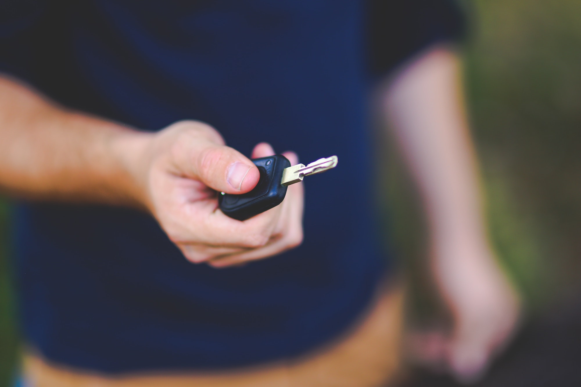 A person holding a car key
