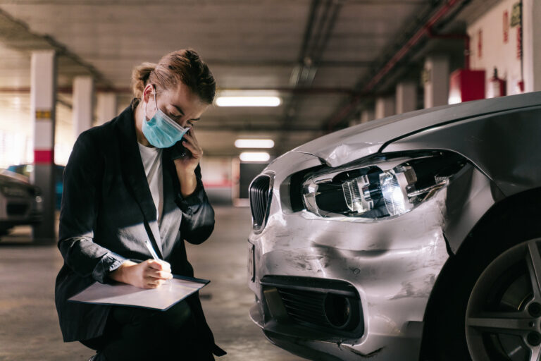 Image of a service employee assessing damage to a loaner vehicle